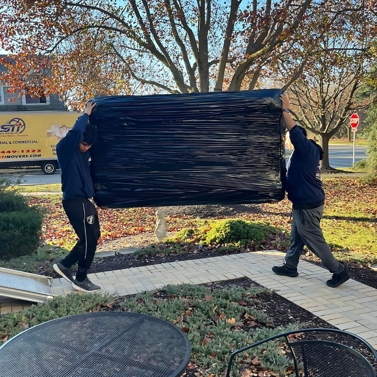 Local Downers Grove movers handling a couch delivery